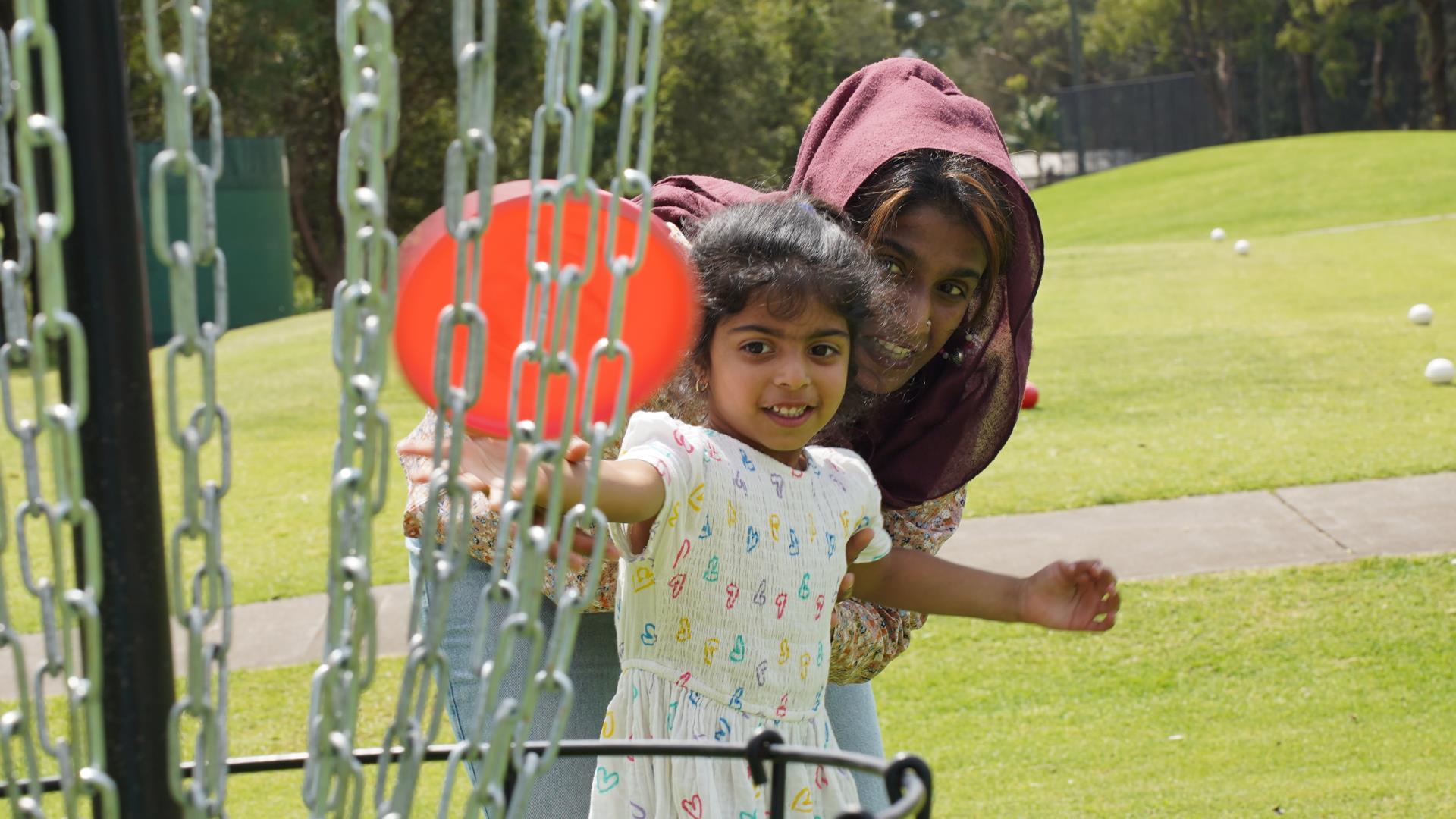 Mother & Daughter playing disc golf