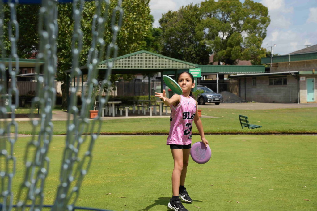 Girl throwing disc